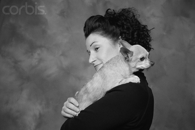 Woman Carrying Dog on Shoulder